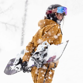 Jones rider Ellery Manning wearing the Women's Shralpinist Stretch Jacket in Sierra Brown