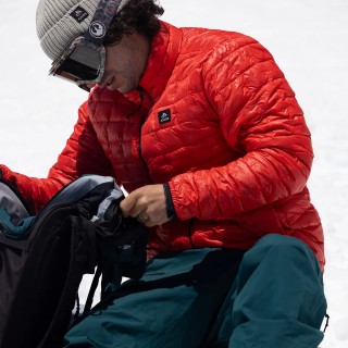 Jones rider Inaki Odriozola wears the Men's Ultra Re-Up Down Recycled Jacket in Lava Red