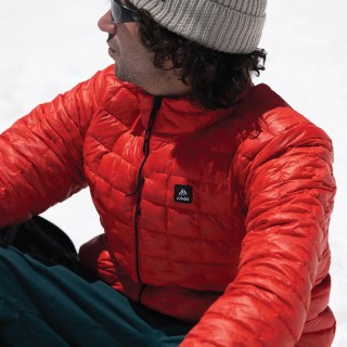 Jones rider Inaki Odriozola wears the Men's Ultra Re-Up Down Recycled Jacket in Lava Red