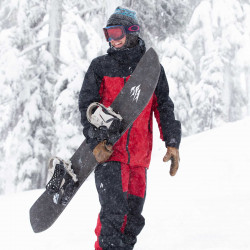 Jones team rider Harry Kearney wearing the Men's Shralpinist Gore-Tex Pro pants in Safety Red
